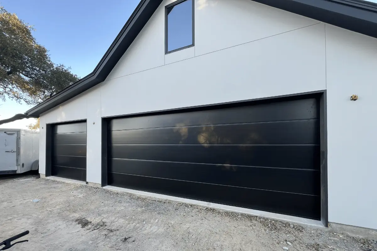 Black flush-panel garage door with a modern finish