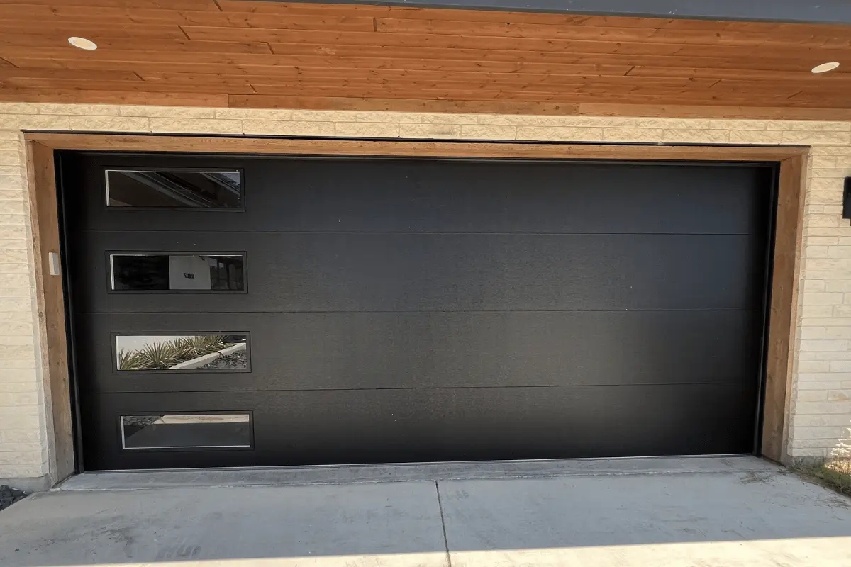 Black flush garage door with side windows after installation