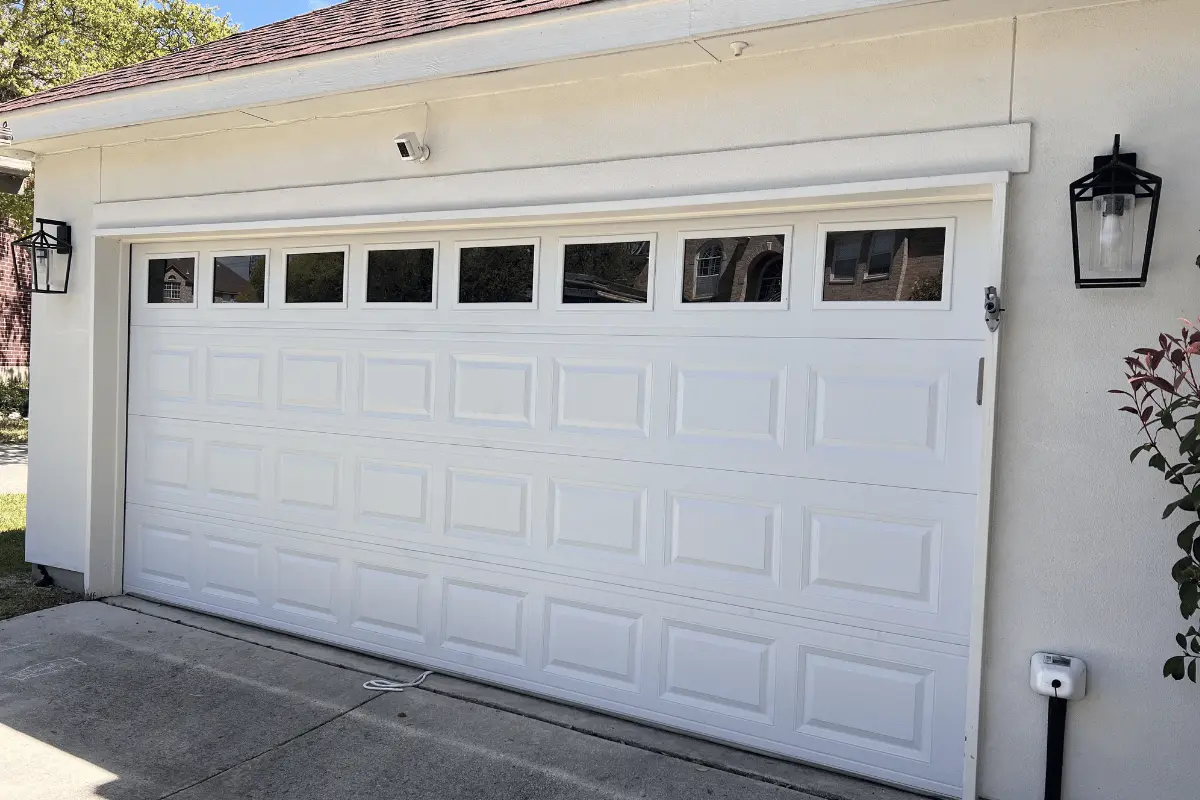 Raised-panel garage door with top windows after installation
